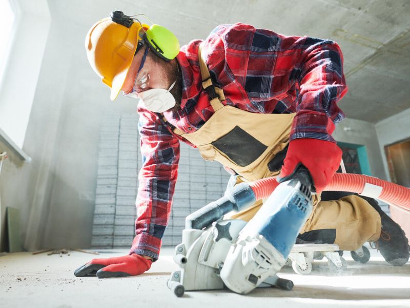 worker in gloves using a power tool