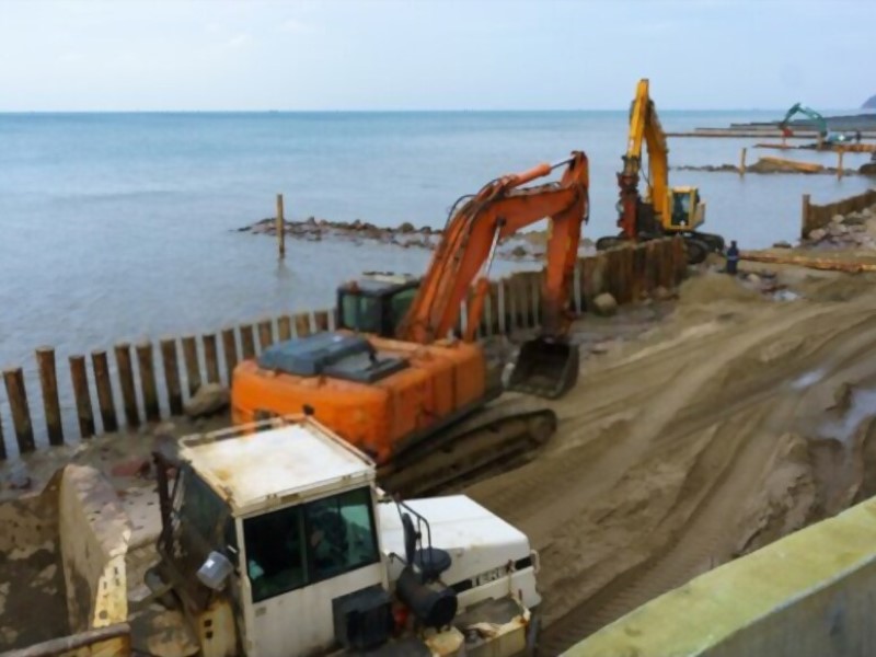 excavators near the sea
